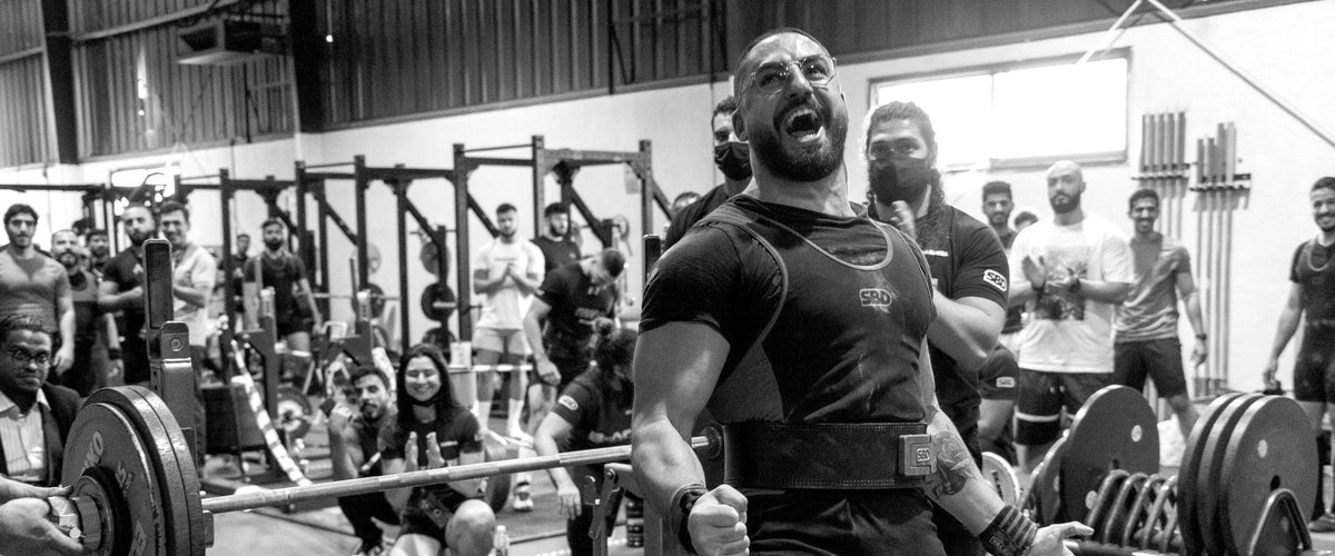Powerlifter celebrating a successful lift at a Desert Barbell competition in Dubai